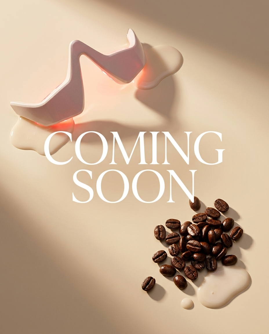HushHour LED under-eye glasses with glowing red light next to scattered coffee beans and cream on a warm beige background, Coming Soon teaser visual